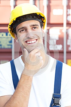 Handsome docker infront of an oversea container photo