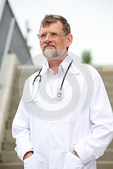 Handsome doctor in his 50s standing outside