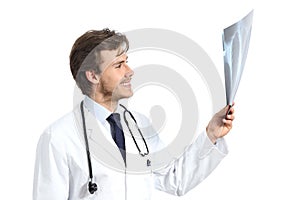 Handsome doctor man examining a radiography