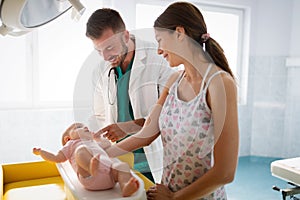 Doctor pediatrician with mother and baby child in clinic. Hospital, examining, child concept.