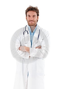 Handsome doctor standing arms crossed smiling