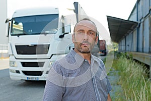 Handsome driver near modern truck outdoors