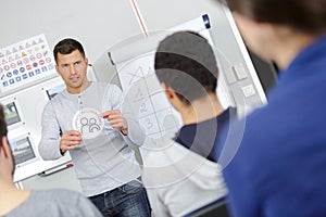 handsome driving instructor giving class