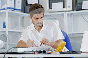 handsome electrician testing induction hobs