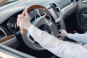 Handsome and elegant man in a car salon