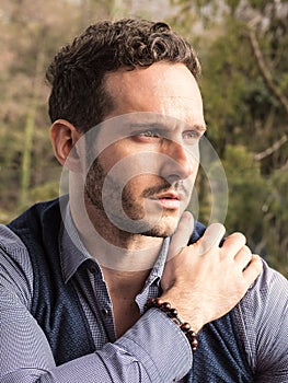 Handsome elegant man outdoor, wearing shirt and vest