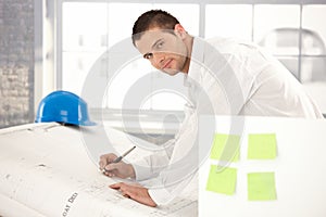 Handsome engineer drawing plans