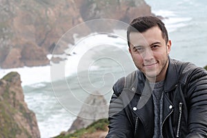 Handsome ethnic man with winter ocean landscape