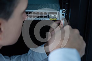 Handsome experienced technician repairing the rack server repair