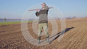 Handsome farm worker with beard with farm tools protrait