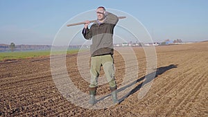 Handsome farm worker with beard with farm tools protrait