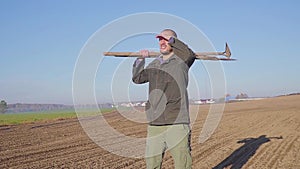 Handsome farm worker with beard with farm tools protrait