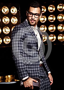 Handsome fashion male model man dressed in elegant suit