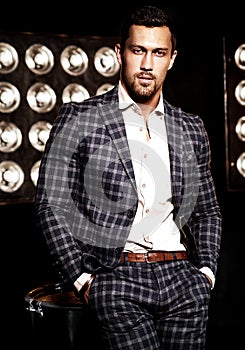 Handsome fashion male model man dressed in elegant suit