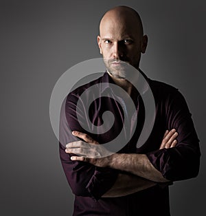 Handsome Fashion Man. Bearded Men Face Portrait in Shirt over dark Gray Background. Elegant Male Model Bald Head and Unsaved