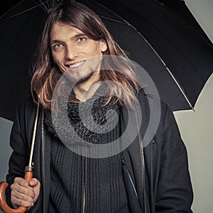 Handsome fashion man portrait wearing black coat.