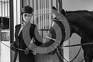 Handsome fashion model in equipment, posing in flock for hourses