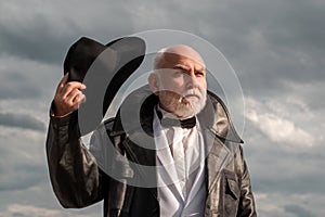 Handsome fashion senior old mature man. Elderly mature greybeard. Close up face portrait of senior. Vintage man in suit.