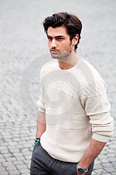 Handsome fashion young man outdoors. Black hair style.