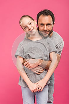 handsome father hugging smiling daughter, isolated