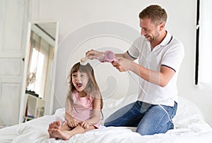 Handsome father takes care of her daughter.Father dries hair wit photo