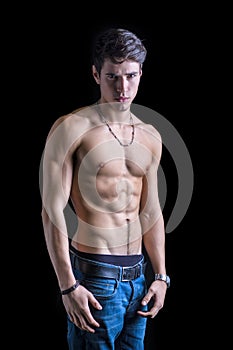 Handsome, fit shirtless young man in jeans photo