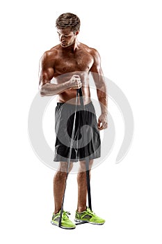 Handsome fitness man working out with rubber band, studio shot.