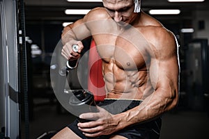 Handsome fitness model holding a shaker in the gym gain muscle