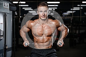 Handsome fitness model train in the gym gain muscle