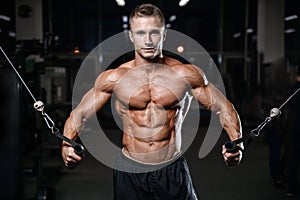 Handsome fitness model train in the gym gain muscle