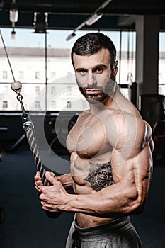 Handsome fitness model train in the gym gain muscle