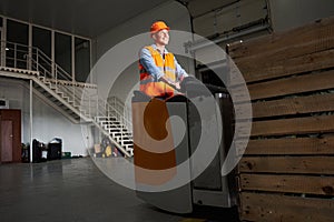 Handsome forklift driver at warehouse photo