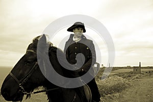 Handsome Male Horse Rider Regency 18th Century Poldark Costume with tin mine ruins and countryside in background