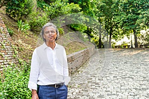 Handsome green eyes relaxed man near medieval walls