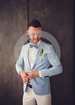 Handsome groom standing in a jacket