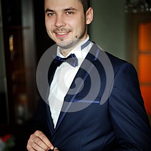 Handsome groom at wedding coat
