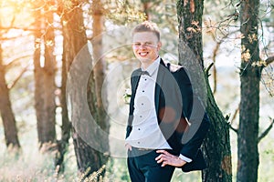 Handsome groom at wedding tuxedo smiling and waiting for bride.