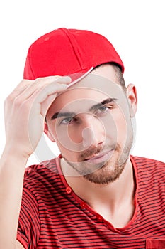 Handsome guy in baseball cap smiling at camera,