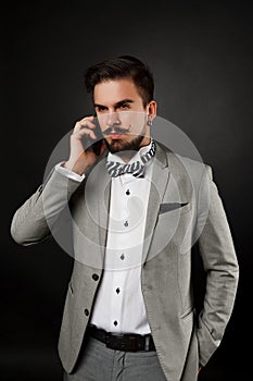 Handsome guy with beard and mustache in suit