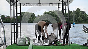 Handsome guy and beautiful girl are getting ready to swim on the wake