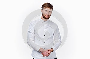 handsome guy blond in a light shirt on a white background cropped view