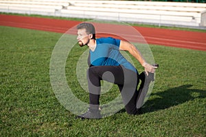 Handsome guy doing stretching after training