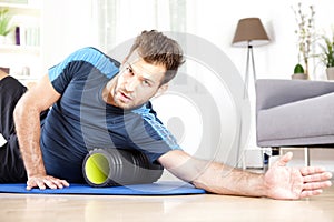 Handsome Guy Lying on Side with Foam Roller
