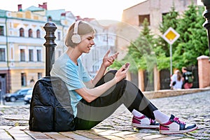 Handsome guy making video call on smartphone, outdoor