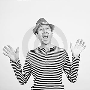 Handsome guy in retro fashion hat and striped shirt. Emotion, gesturing and lifestyle concept