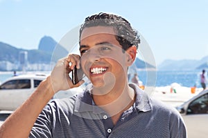 Handsome guy at Rio de Janeiro speaking at phone