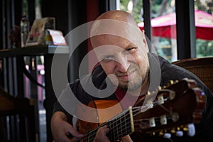 Handsome guy showcases musical talent with acoustic guitar at show