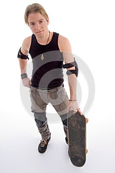 Handsome guy standing with skateboard