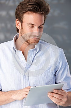 Handsome guy using touchscreen computer