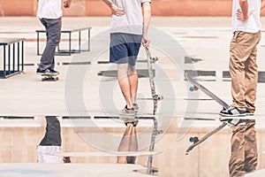 Handsome guys with skateboard at freestyle park outdoors